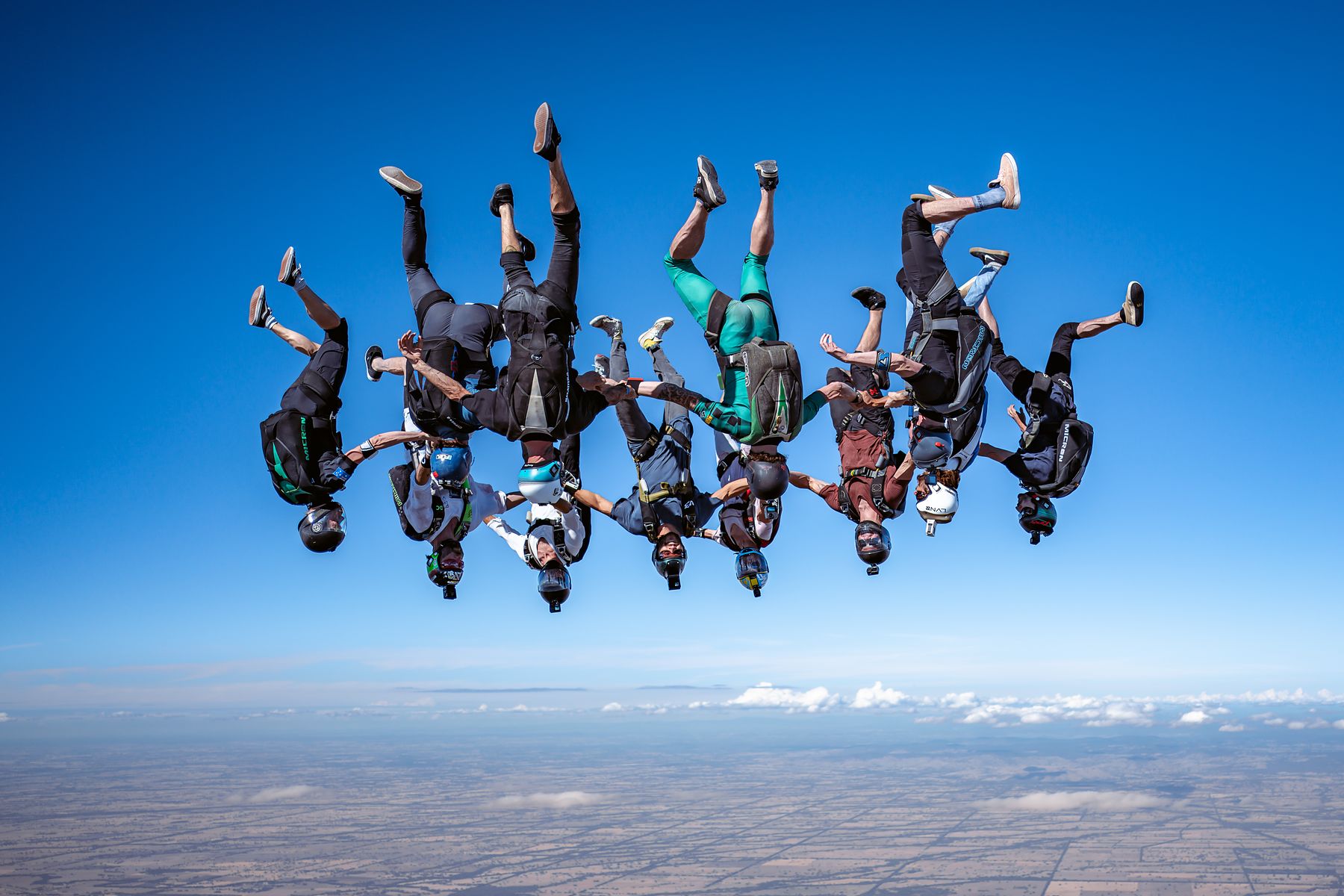 A large freefall formation gripped up against deep blue sky