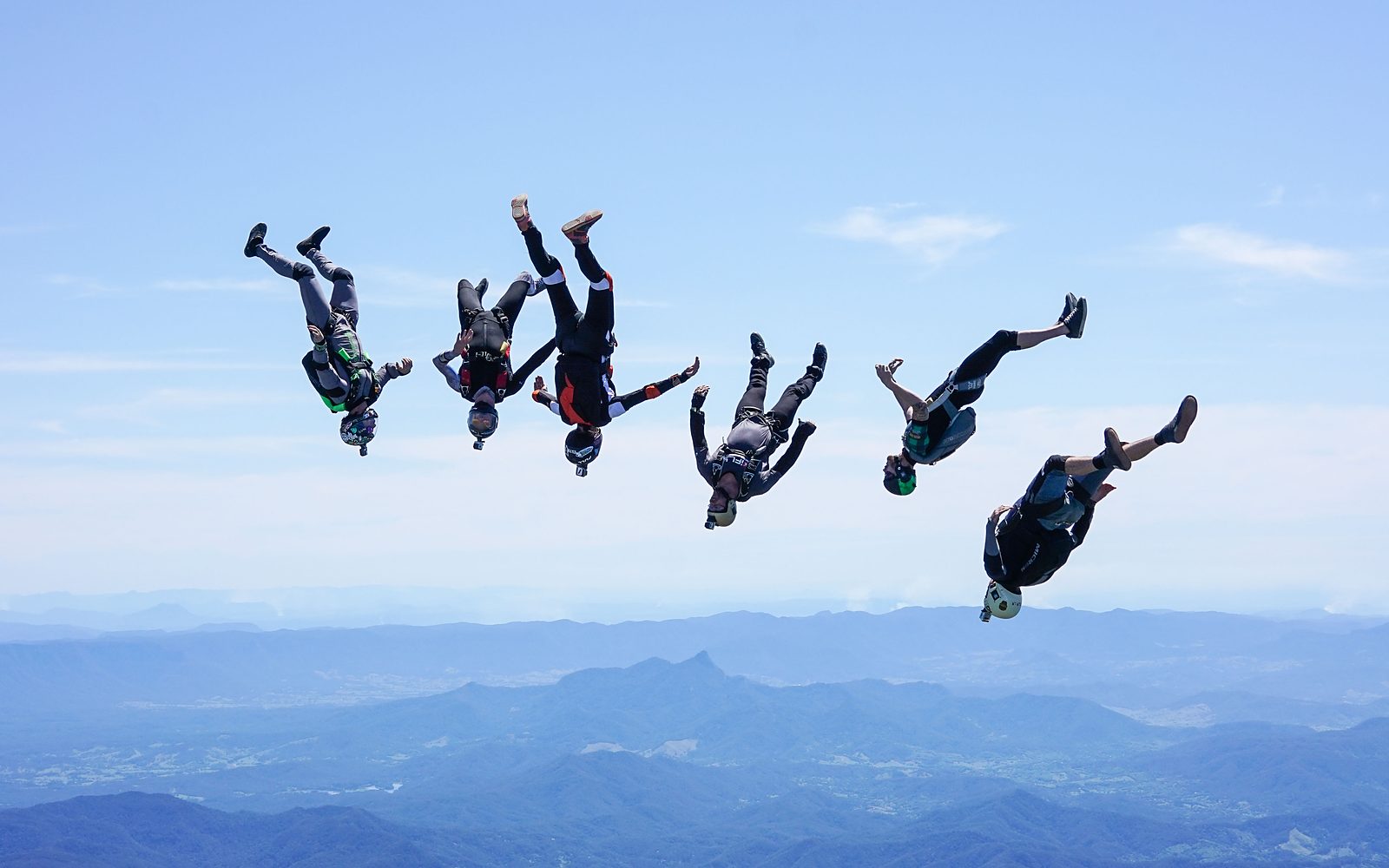 A six-way head-down formation over the mountains at altitude