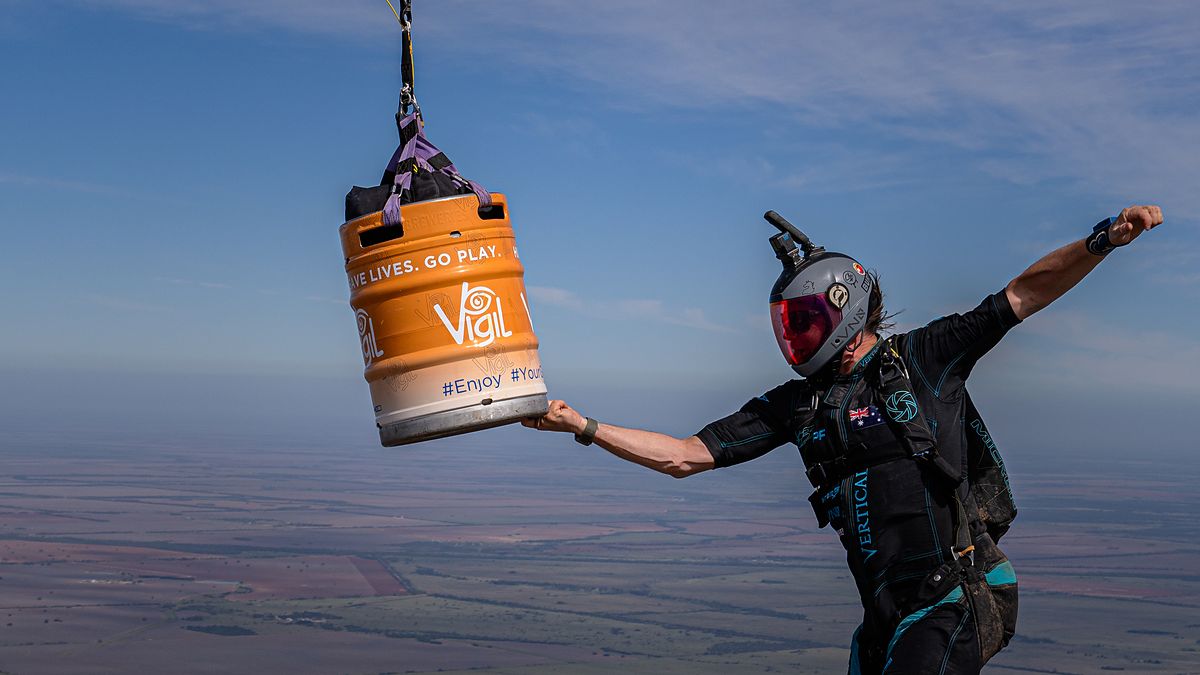 A flyer reaching out to a barrel falling beside them