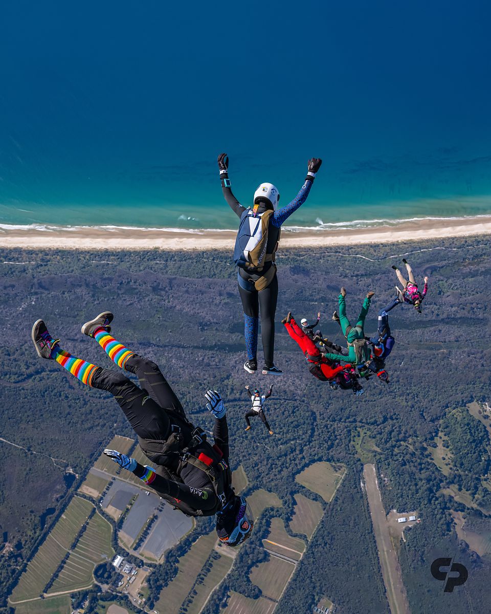 Freeflyers over the beach with the surf line below