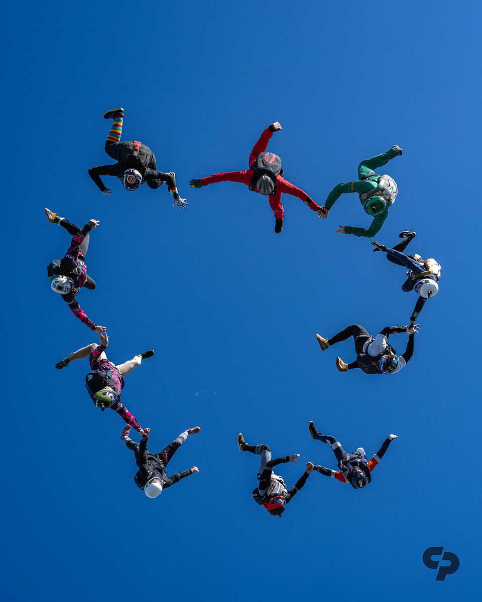 A round freefall formation against deep blue sky