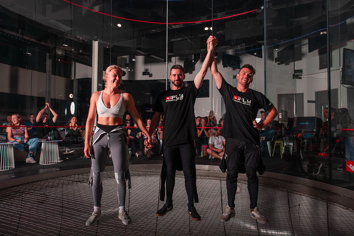 A competitor's hand raised at the end of a Body Piloting match