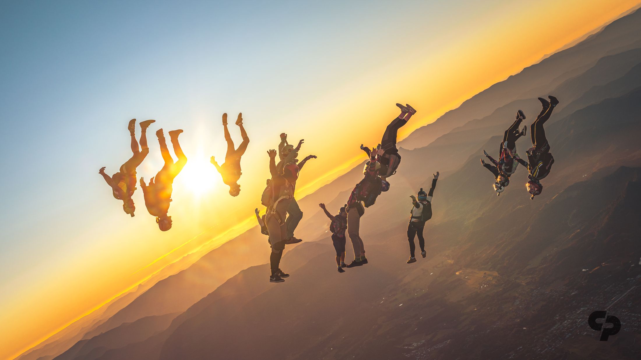 A freefly group racing into the sunset