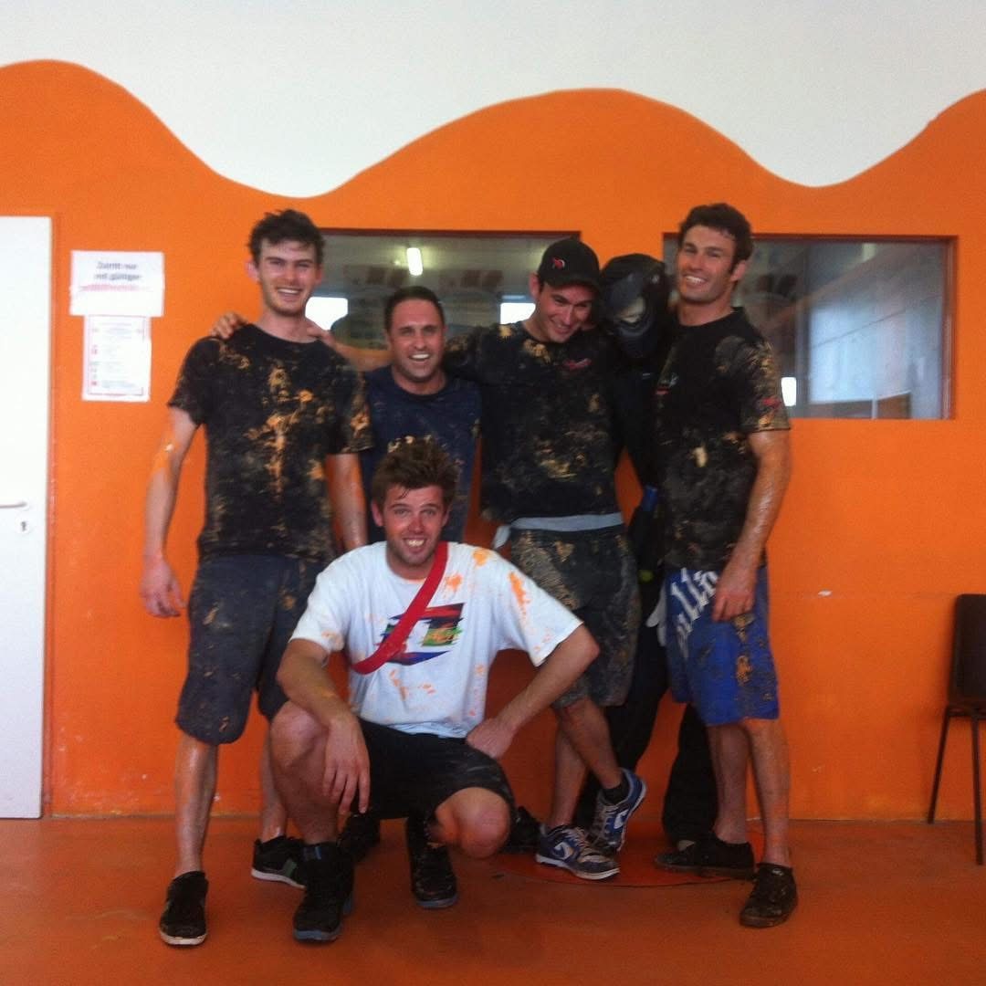 A crew covered in paint after a camp