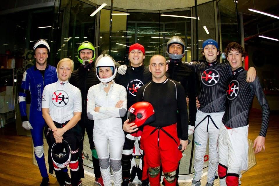 A tunnel group in flying suits and helmets