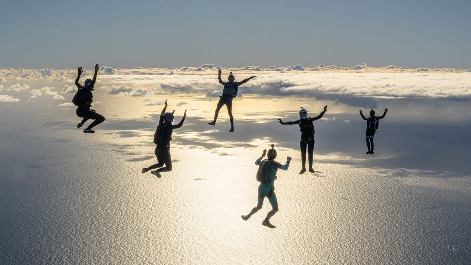 Silhouettes over silver cloud