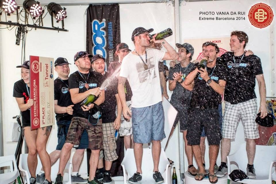 Team Southern Fly on the podium in Barcelona: Joe Grealy spraying the champagne, with Mason Corby, Keith Grealy and Antonio Arias