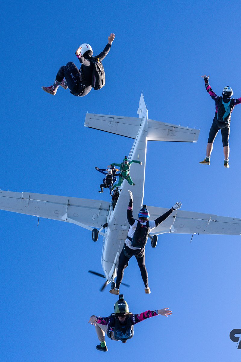 A flyer hanging off the aircraft strut before letting go